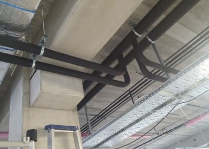 Increasing building efficiency with insulating pipe support